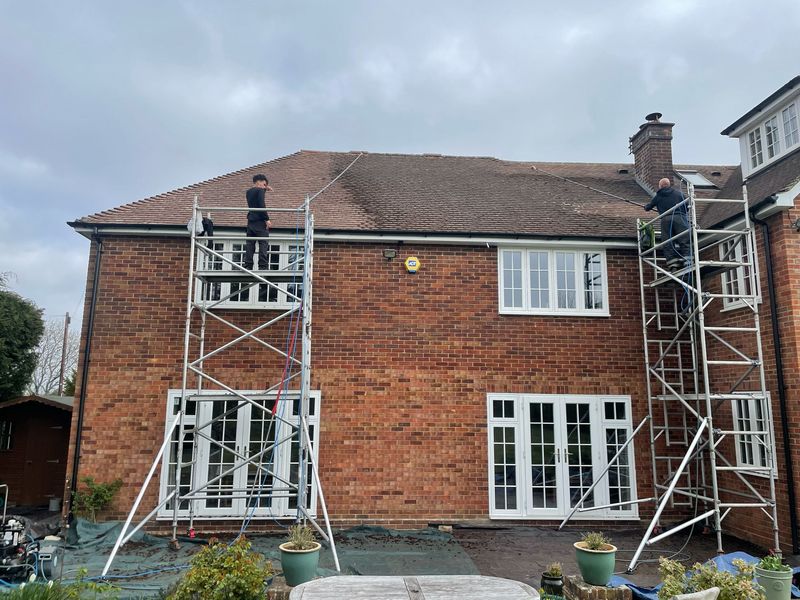 Roof cleaning carried out safely from scaffold towers by The Roof Moss Cleaners in Reigate